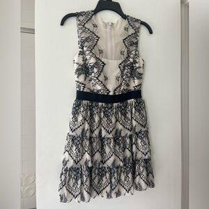 BCBGMaxAzaria Ivory and Black Collier dress with Scalloped tiered lace
